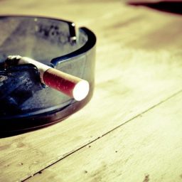 lit cigarette in an ash tray