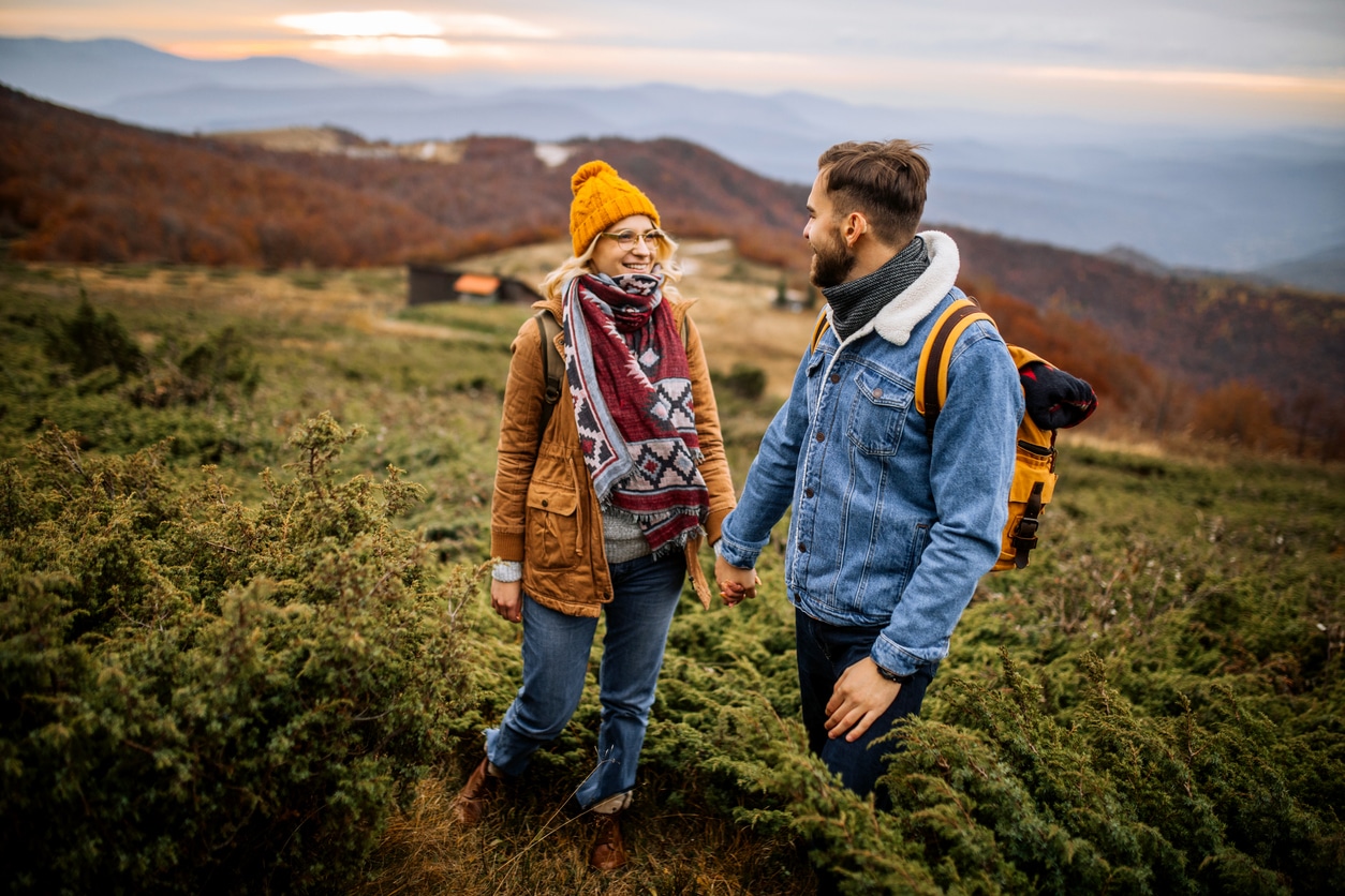 Man with hearing aid talks with partner on hike