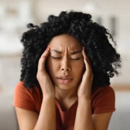 Stressed woman rubbing her temples