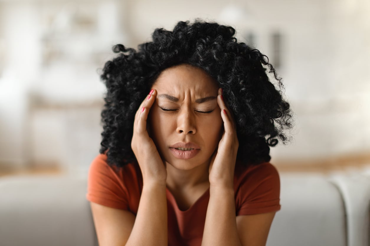 Stressed woman rubbing her temples